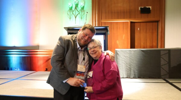 John Bry (left) poses with Mary Means (right) for a celebratory photo. They hold John's Mary Means Leadership Award.