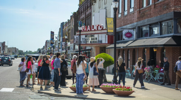 A group of people look at buildings.