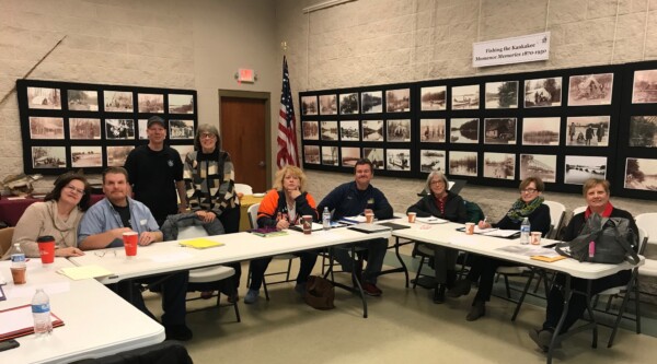 Momence, Illinois board meeting. People setting at a group of long tables with papers and notebooks.