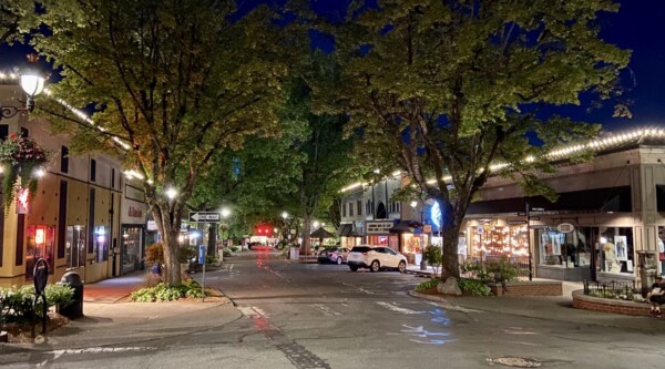 Camas, Washington at night with roofline lighting and outdoor dining