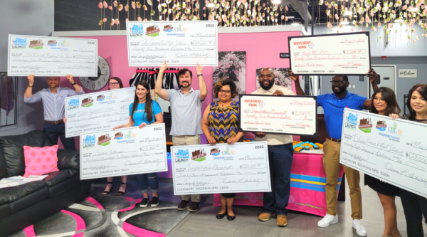 Grant recipients holding large award checks