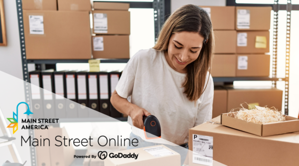 A woman scans packages in an e-commerce warehouse.