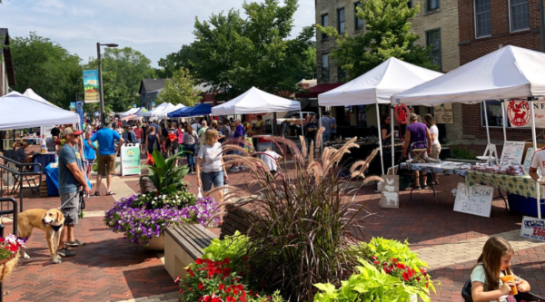 People enjoying an outdoor downtown market