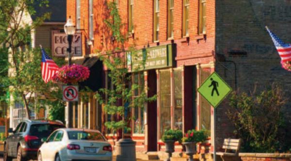 Downtown street with cars and red brick building