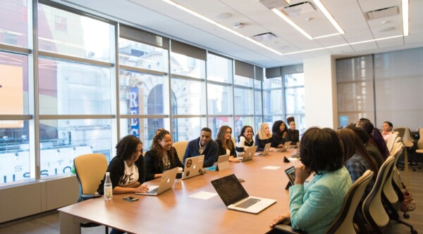 People sitting around a large table during a meeting