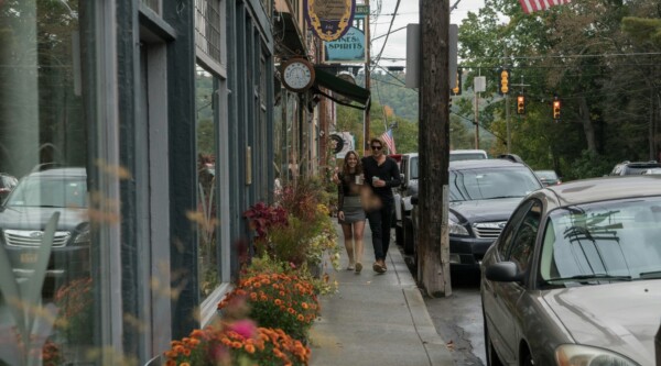 Two people walking down the sidewalk in Narrowsburg, New York