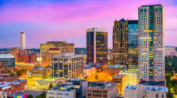 Illuminated aerial view of Birmingham skyline at night.