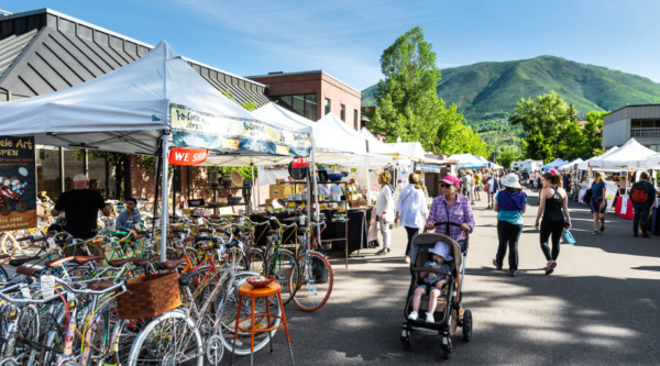 People shopping at an outdoor farmers market