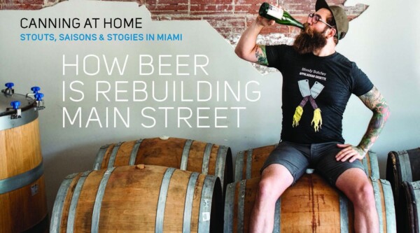 BeerAdvocate magazine cover with photo of man drinking a bottled beer while sitting on a barrel. Text reads, "How Beer is Rebuilding Main Street."