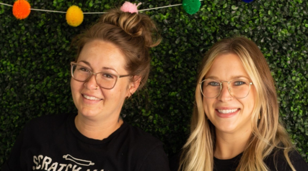 Two smiling women wearing black t-shirts reading, "Scratch Made Bakery."