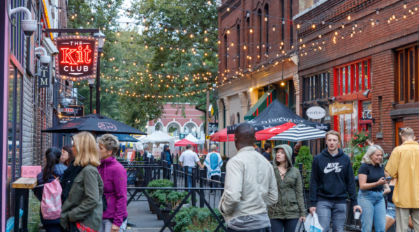 People walking around a historic downtown shopping district