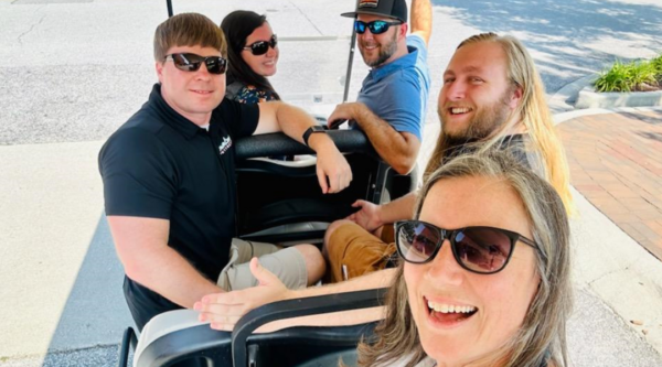 Main Streeters from Wytheville, VA, and Florence, SC, sit in a golf cart