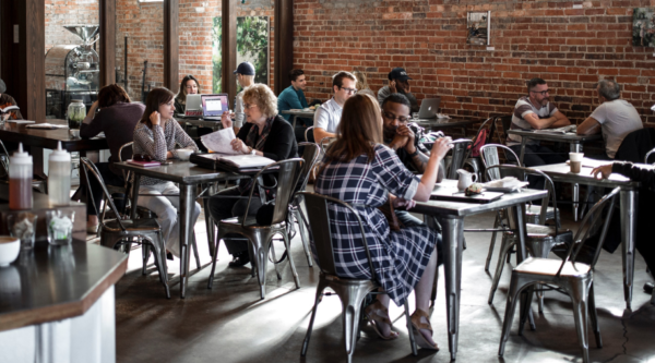 People sitting at tables in a cafe