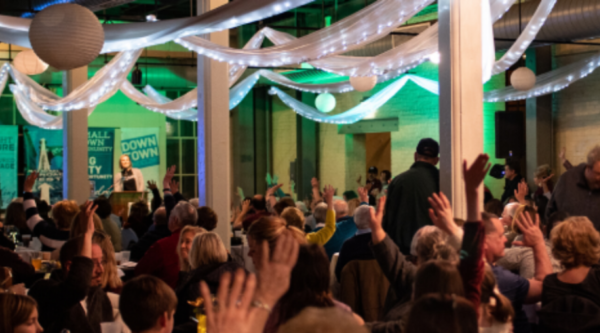 People raising their hands to show support for small businesses