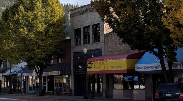 Shops with colorful awnings along a historic Main Street