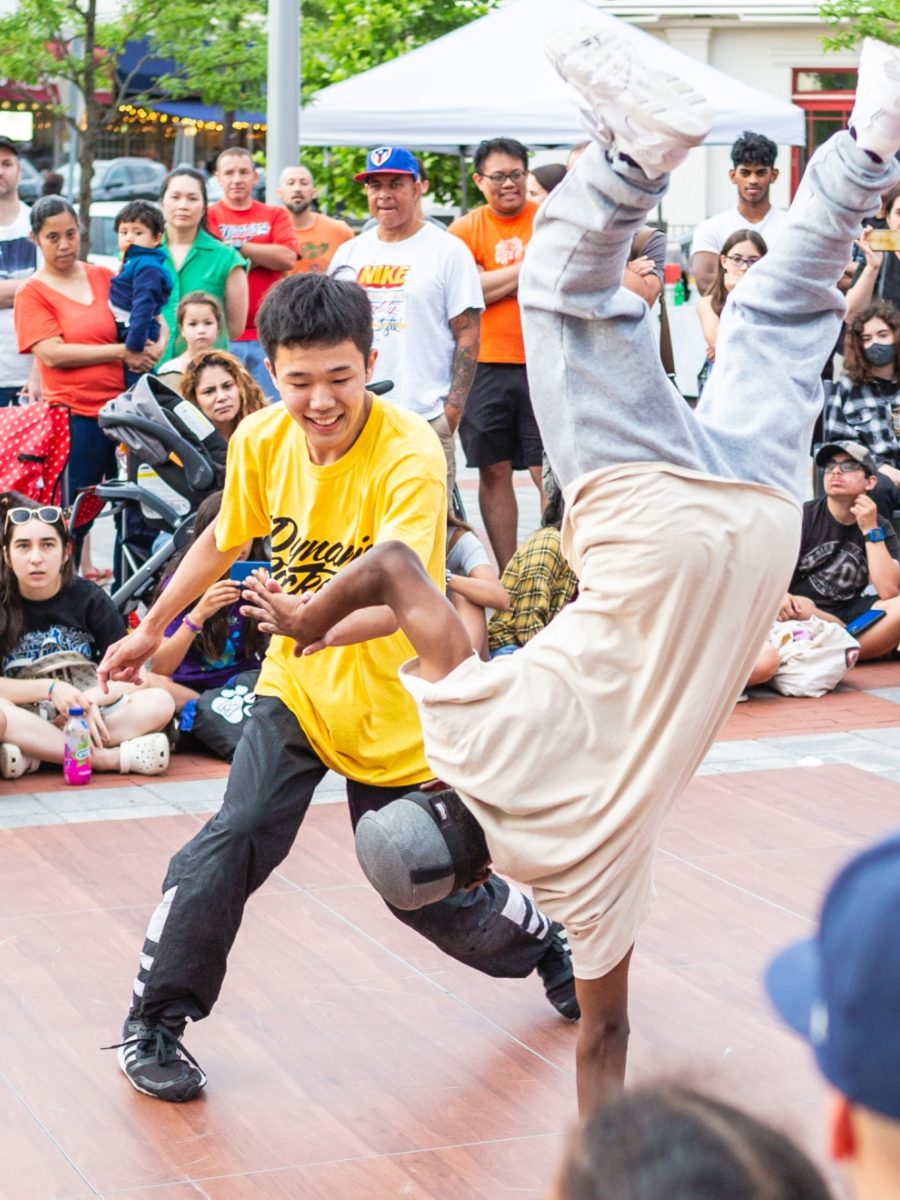 Kids breakdancing in front of an audience.